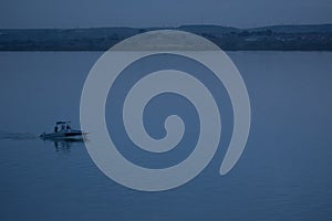 Boat at blue hour. Motorboat alone in the lake during blue twilight hour in Constanta, Romania