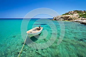 Boat on blue lagoon of Vai beach