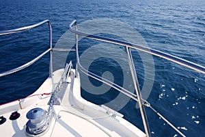 Boat bow sailing sea with anchor chain winch photo