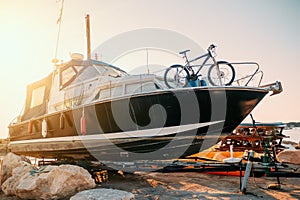 Boat cabin motorboat cruiser yacht on shore ready for maintenance and transportation