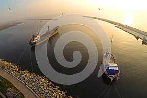 Boat in calm sea at sunset. Aerial Shot.