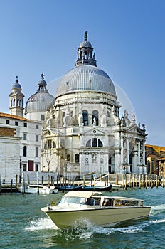 Boat on Canal Grande with Basilica di Santa Maria della Salute in the background in Venice