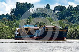 Boat carrying huge trucks for coal transportation in Berau, Kalimantan