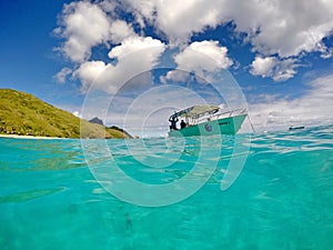 Boat in clear blue water in Fiji