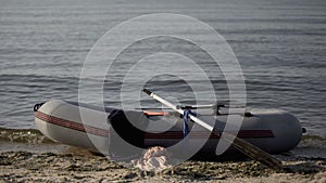 Boat with clothes moored to shore, illegal transfer of refugee across sea border