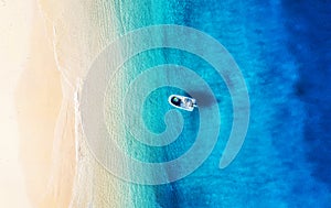 Boat and coast from top view. Turquoise water background from drone. Summer seascape from air.