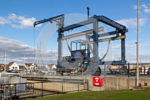 a boat crane lift on a marina use for lifting boats out of the water for repairs