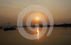 Boat crossing the Hoogly river in Kolkata during sunset