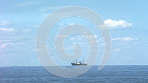 Boat Cruising on Blue Calm Lake in Sunny Day with White Cumulus Clouds