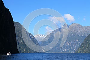 Boat cruising in milford sound, new zealand