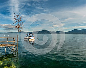 A boat on the crystal clear lake Geneva, Switzerland