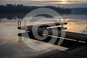 Boat dock on a calm sunrise morning on the river