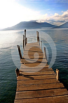 Boat dock on lake with volcano- Lake Atitlan, Guat photo