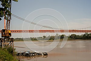 boat dock on the Madre de Dios River, with the Presidente Guillermo Billinghurst suspension bridge Puerto Maldonado,