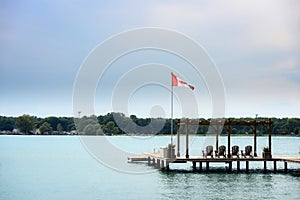 Boat dock on a river with Canadian flag