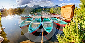 Boat on the dock surrounded mountains. Fantastic Shtrbske Pleso