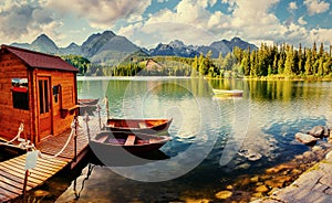 Boat on the dock surrounded mountains. Fantastic Shtrbske Pleso