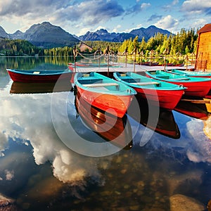 Boat on the dock surrounded mountains. Fantastic Shtrbske Pleso