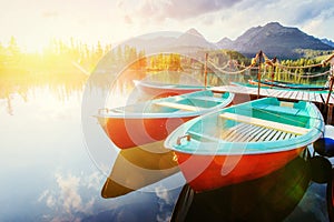 Boat on the dock surrounded mountains. Fantastic Shtrbske Pleso