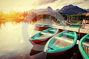 Boat on the dock surrounded mountains. Fantastic Shtrbske Pleso