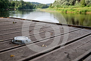 Boat dock and wooden footbridge by the river with a beautiful view of nature