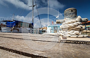 Boat docking point at a marina - rope fixed around a belay photo