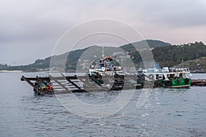 boat doing salvage work on a mussel farm in Vigo