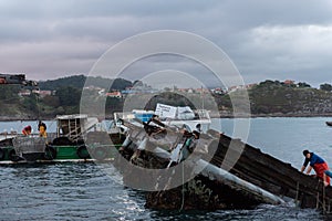 Vigo, Pontevedra, Spain, October 24, 2022: salvage work on a marine farm in Vigo