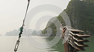 A boat with a dragon`s head floating in the ocean. Vietnam. Ha Long Bay.