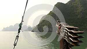 A boat with a dragon`s head floating in the ocean. Vietnam. Ha Long Bay.