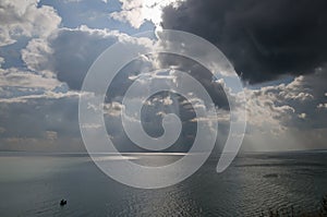 Boat and dramatic clouds over the sea