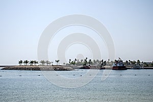 Boat dredger creating land coastline Souly Bay Salalah Oman 2