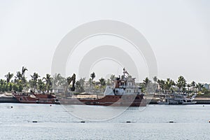 Boat dredger creating land coastline Souly Bay Salalah Oman 3
