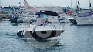 A boat driven by a man and his friend arrives at the port of Valencia