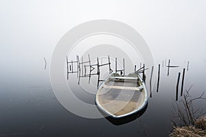 Boat filled with ice in a misty lake