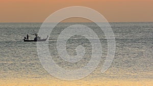 Boat with fishemen at sunset