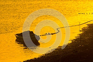 Boat with fishing supply nets with noone on sunset photo