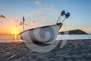 Boat fishing . wooden boat . old boat . sunset boat . sunset beach . beach sand . boat in beach sand . boat in mediterranean sea .