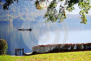 Boat floating on the famous Hallstatt lake in a autumn foggy morning