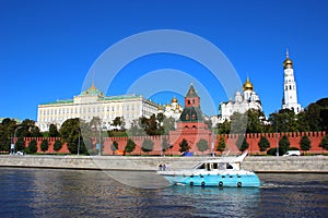 Boat floating on the river in the background of the Moscow Kremlin