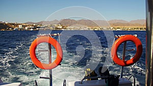 Boat is Floating on the Waves and Leaves a Trail in the Red Sea