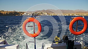 Boat is Floating on the Waves and Leaves a Trail in the Red Sea