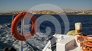 Boat is Floating on the Waves and Leaves a Trail in the Red Sea