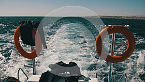 Boat is Floating on the Waves and Leaves a Trail in the Red Sea