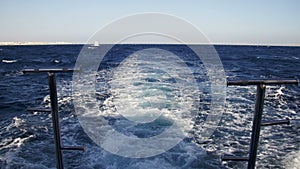 Boat is Floating on the Waves and Leaves a Trail in the Red Sea