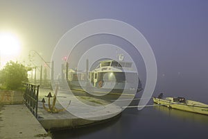 A boat in the fog at the evening