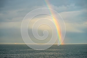 The boat follow the rainbow on the black sea photo