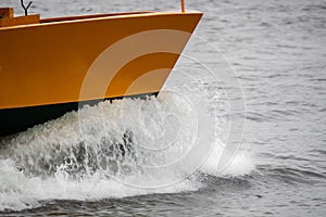 A boat in full speed over the water