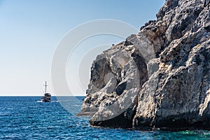 Boat full of tourists sailing in the Ionian sea near Karpathos