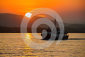 Boat glides under sunsets golden glow on Lake Baikal